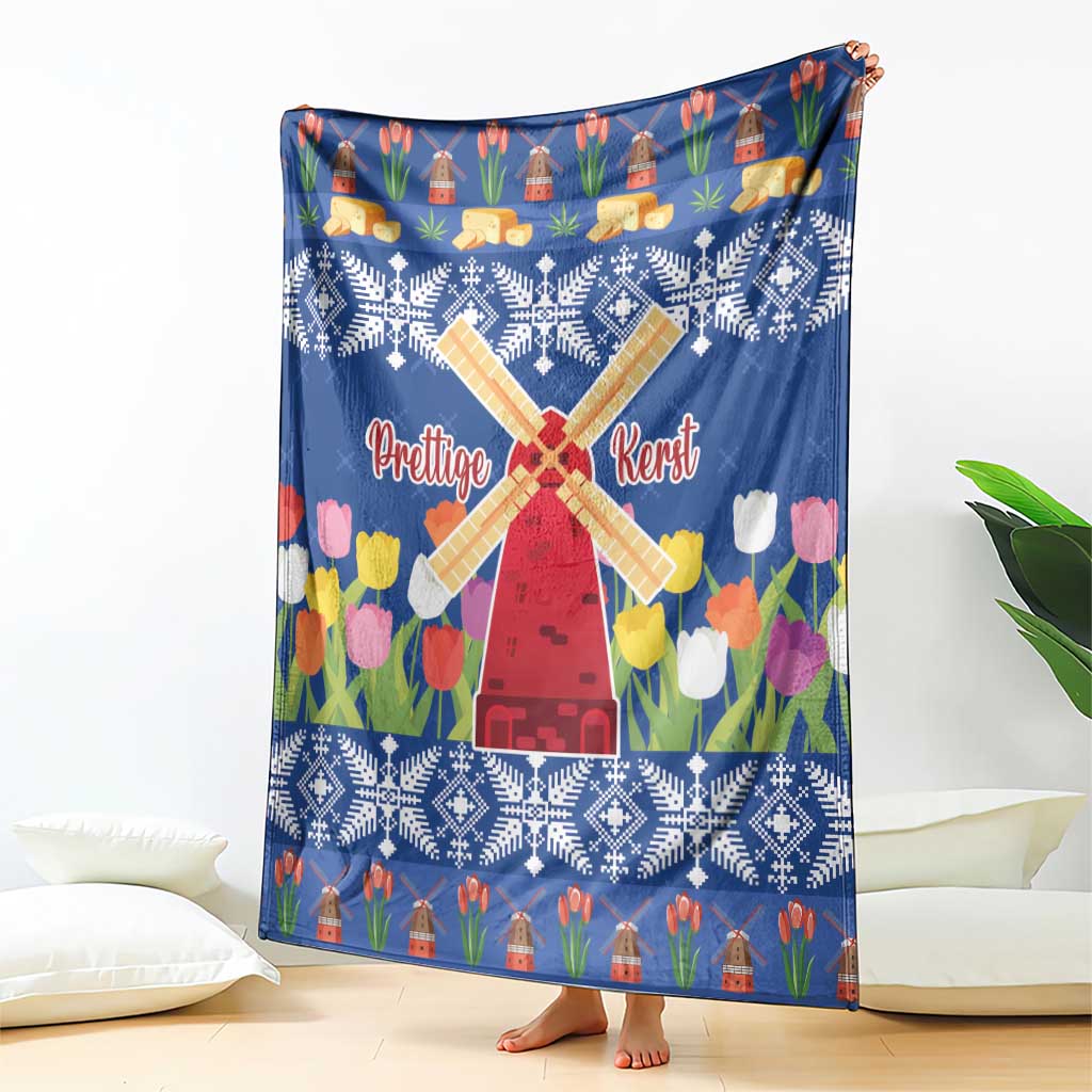Blue Christmas blanket with windmill and tulip flower print, fully spread on the floor.