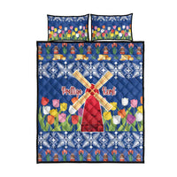 Blue quilt bed set with windmill center, tulip flowers, and snowflake trim; includes two pillows