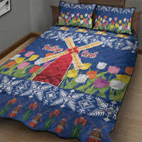Blue quilt bed set featuring windmill design, tulip flowers, and white snowflake pattern