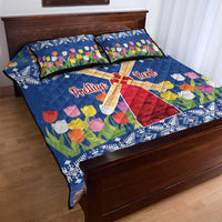 Blue quilt bed set with windmill graphic, tulip flowers, and snowflake pattern; includes pillows