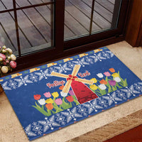 Blue Christmas rubber doormat with windmill and tulip flowers, placed at entry