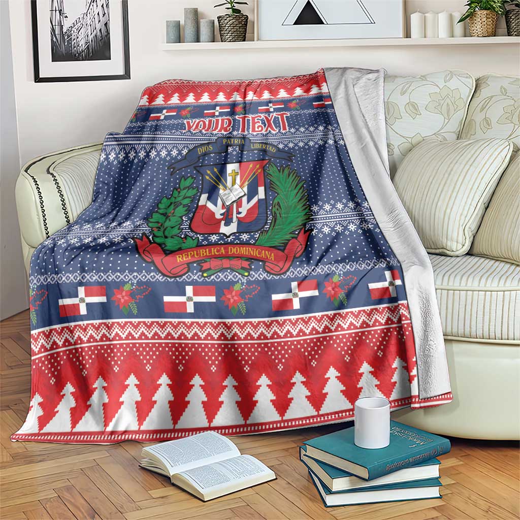 Personalized Christmas blanket with blue and red holiday pattern, crest and trees, draped on sofa