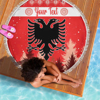 Red round beach blanket with white fringe, black eagle emblem over forest, “Your Text”