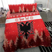 Red Christmas bedding set with two pillows; eagle emblem centered on pine tree background.