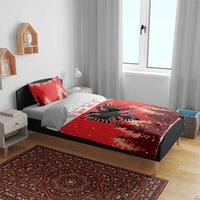 Red Christmas bedding set on bed; eagle emblem on duvet with snowy pine forest pattern.