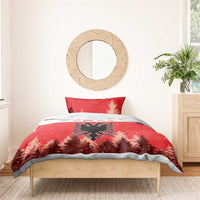 Red Christmas bedding set on bed; double-headed eagle emblem with snowy pine trees.