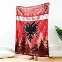 Red Christmas blanket with striped border, personalized text, and double-headed eagle center