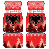 Set of four red car mats with festive border, eagle and pine trees, 'Your Text'.