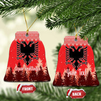 Red ceramic bell-shaped ornament with double-headed eagle and personalized holiday lettering, hanging loop.