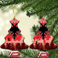 Red ceramic Christmas tree-shaped ornament with double-headed eagle and personalized lettering, hanging loop.