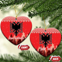 Red ceramic heart-shaped ornament with double-headed eagle and personalized holiday lettering, hanging loop.