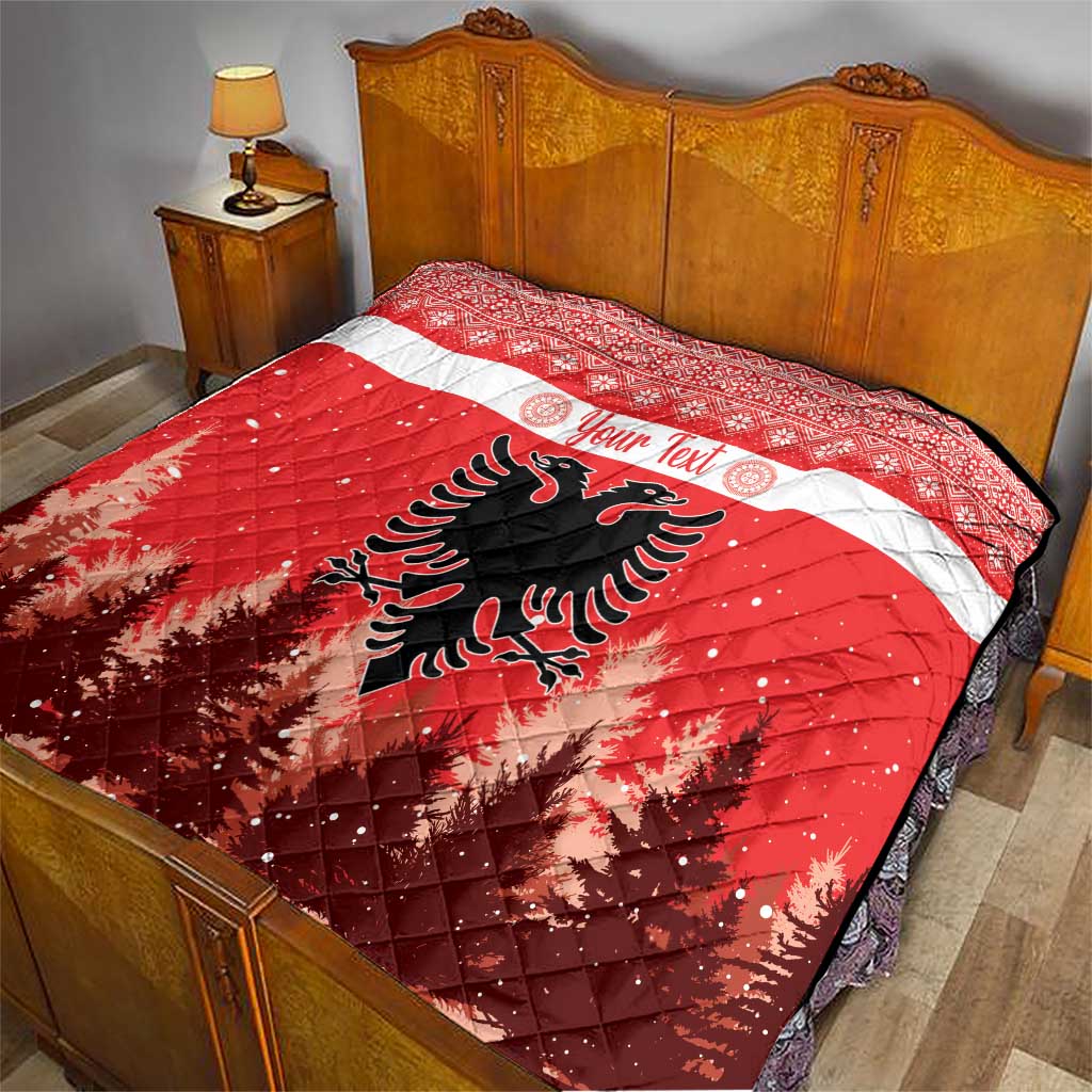 Red and white quilt on a bed with personalized text and Albanian double-headed eagle