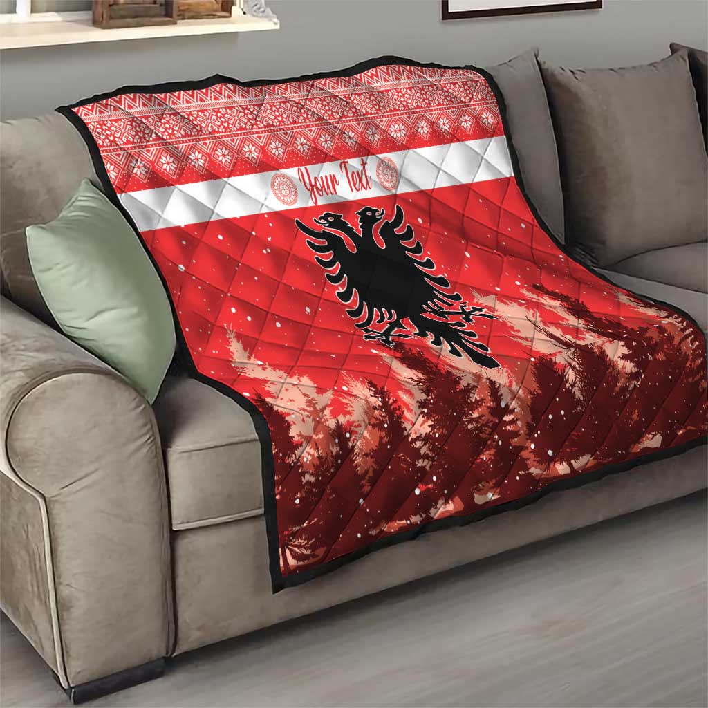 Red and white quilt with personalized text and Albanian double-headed eagle on sofa