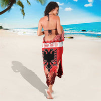 Red Albania sarong wrap with eagle and pine trees; white stripe; Your Text across center.