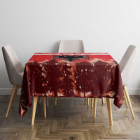 Red Christmas tablecloth covering dining table with speckled pine and eagle pattern