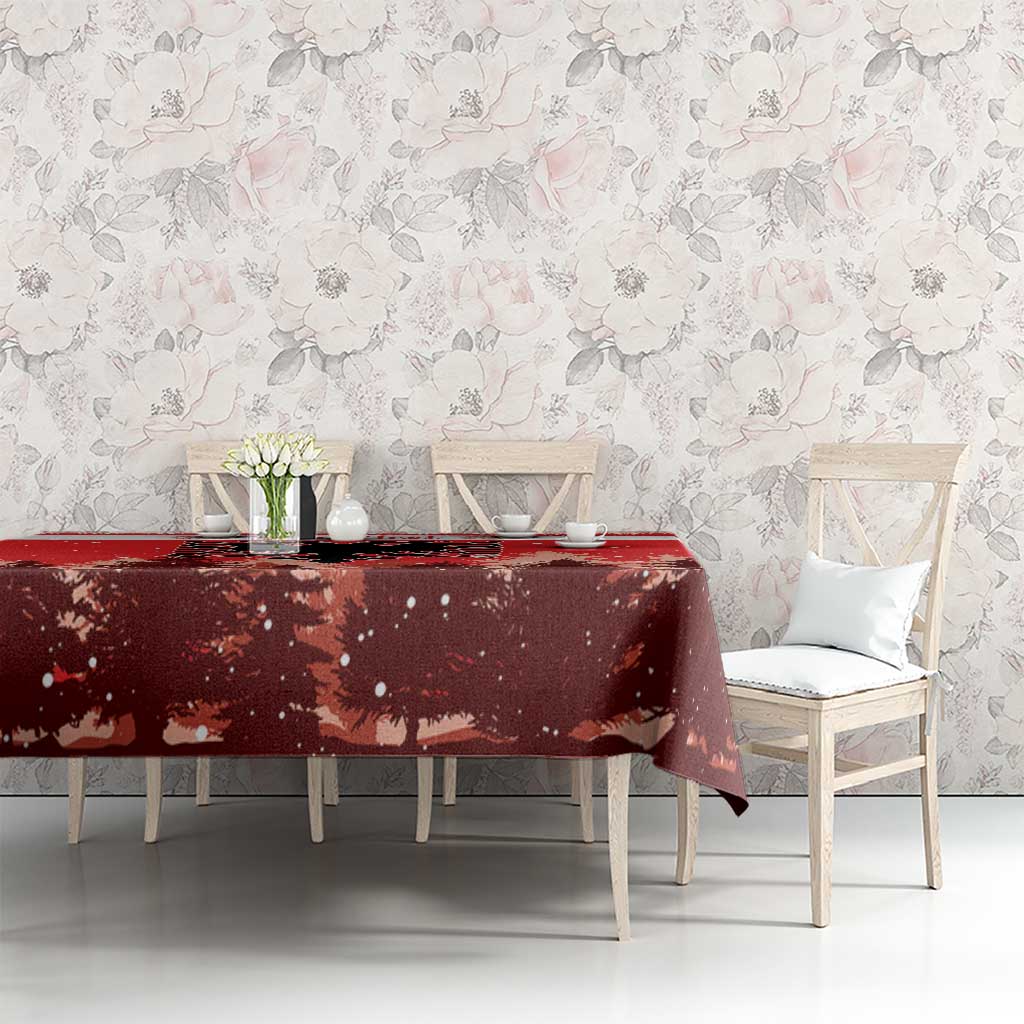 Red Christmas tablecloth on dining table with pine tree silhouettes and eagle emblem