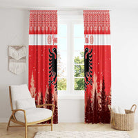Red Christmas window curtain pair with white band and black eagle; snowy pine trees