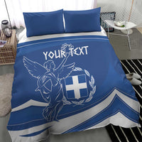 Blue duvet and two pillows with Greek flag day angel-and-cross emblem and ribbon stripes