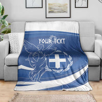 Personalized Greek flag day blanket draped on a sofa, blue and white angel crest
