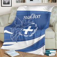 Personalized Greek flag day blanket on couch with blue band, angel and shield emblem