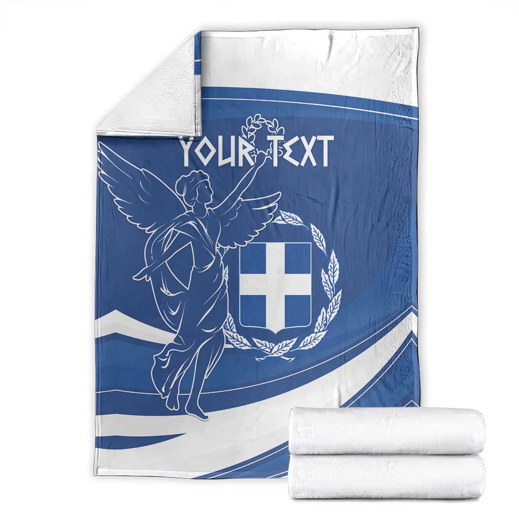 Personalized Greek flag day blanket with blue-and-white angel crest, folded with rolled towels