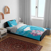Turquoise bedding set on bed: white stripe arcs, map graphic, orchids, and “Your Text”