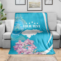 Personalized blue and white blanket on grey couch with 'YOUR TEXT' and star accents