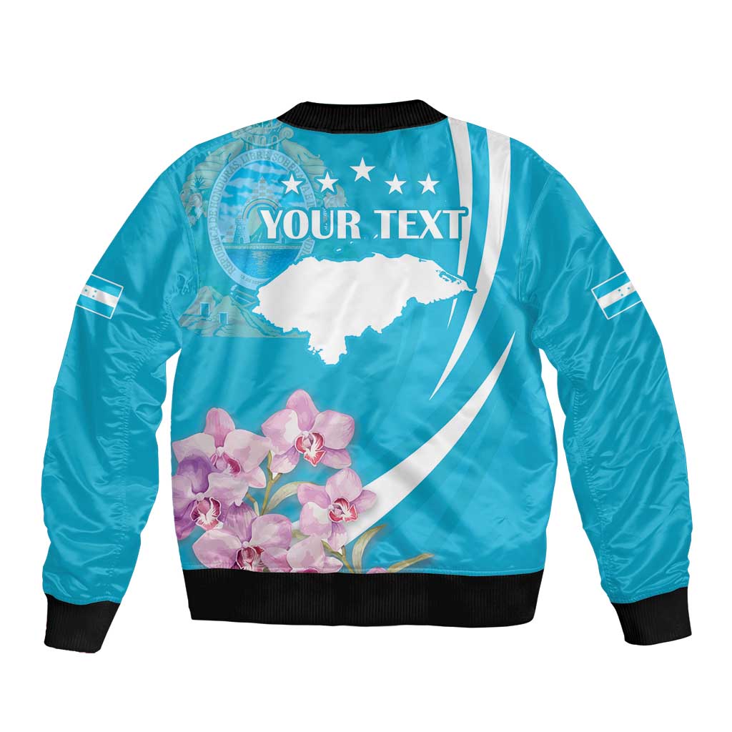 Blue bomber jacket back graphic with white map, pink orchids, and 'YOUR TEXT'; ribbed hem