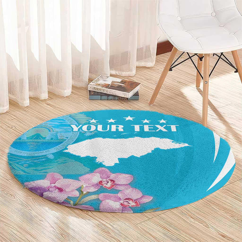 Blue round area rug with white deer silhouette, 'YOUR TEXT' and purple orchids along edge.