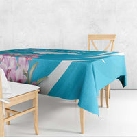Blue tablecloth with white diagonal stripe and purple floral print, draped over a table