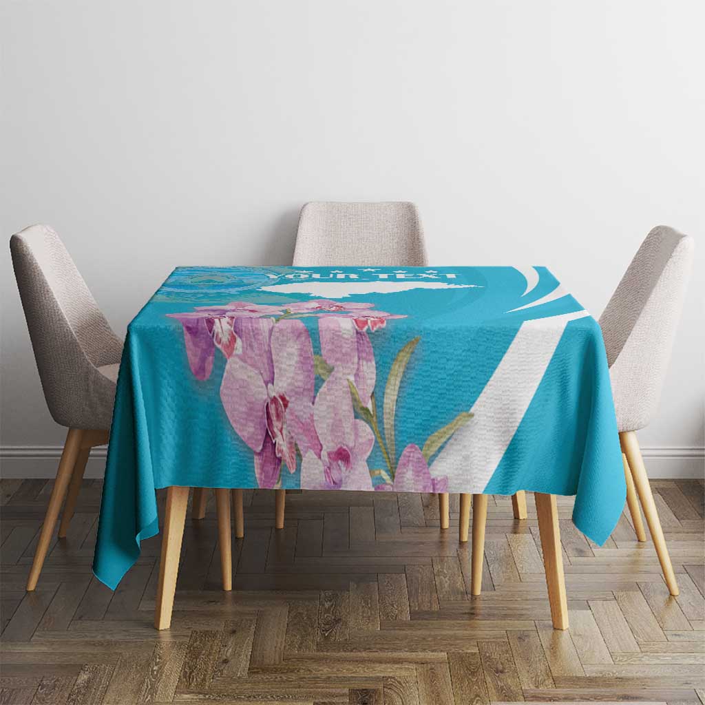 Blue tablecloth with white curved stripe and purple flower print across table