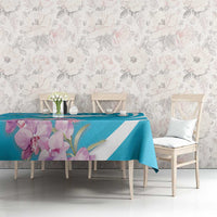 Blue tablecloth with white stripe and large purple floral print on a buffet table