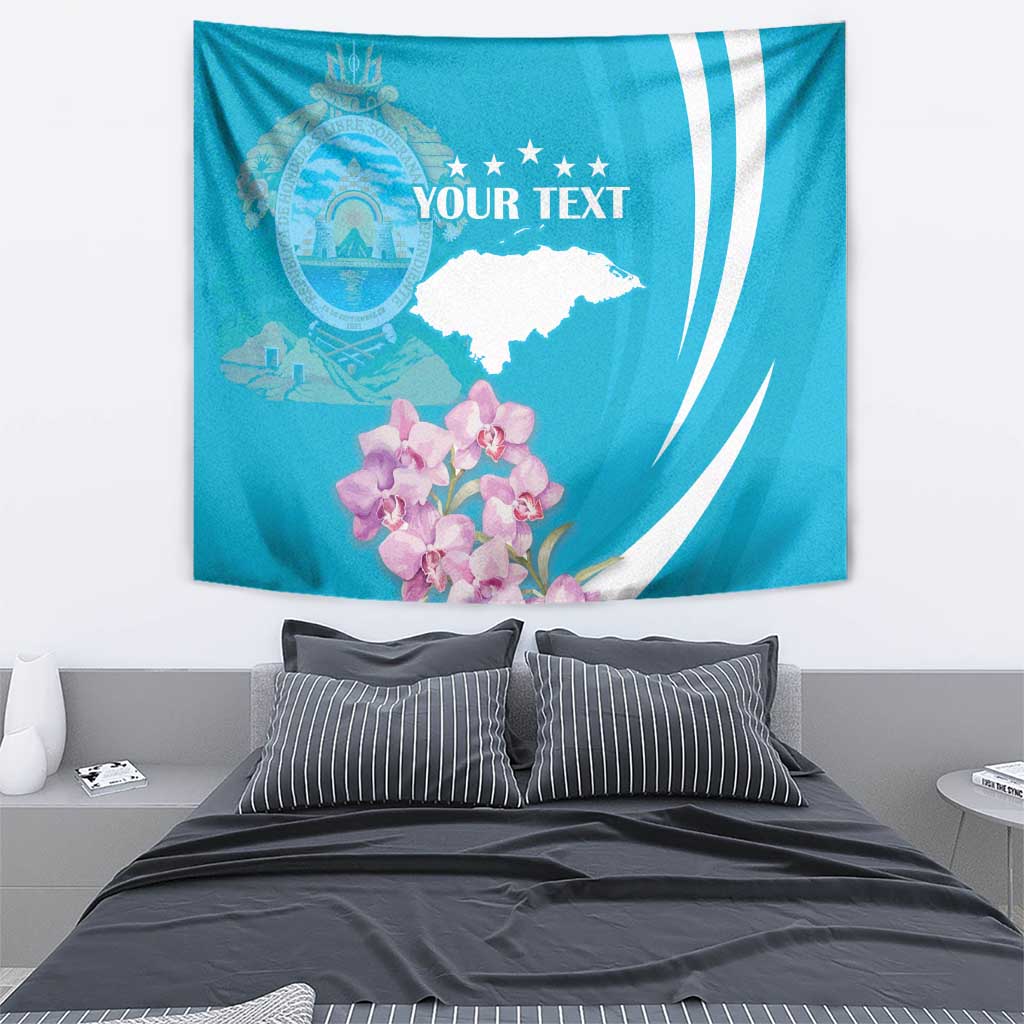 Blue tapestry wall hanging showing crest, stars, white map shape, and pink orchid cluster.