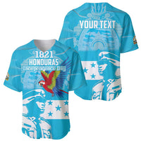 Pair of blue baseball jerseys with 1821 Honduras Independence Day text and macaw art