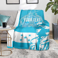 Blue and white personalized blanket showing “YOUR TEXT,” stars, and figure print