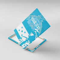 Blue tilted canvas wall art showing 'YOUR TEXT' with white statue and star accents