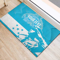 Blue rubber doormat on wood floor with bird graphic, 'YOUR TEXT' text, and star stripe