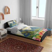Tropical hibiscus duvet with blue mountain peaks, palm trees, and colorful flower hem on bed