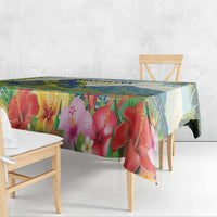 Outdoor tablecloth featuring large red hibiscus blossoms and leafy tropical pattern