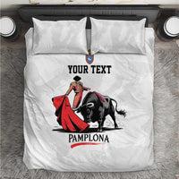 White bedding set with bull and matador graphic, 'YOUR TEXT' and 'PAMPLONA'.