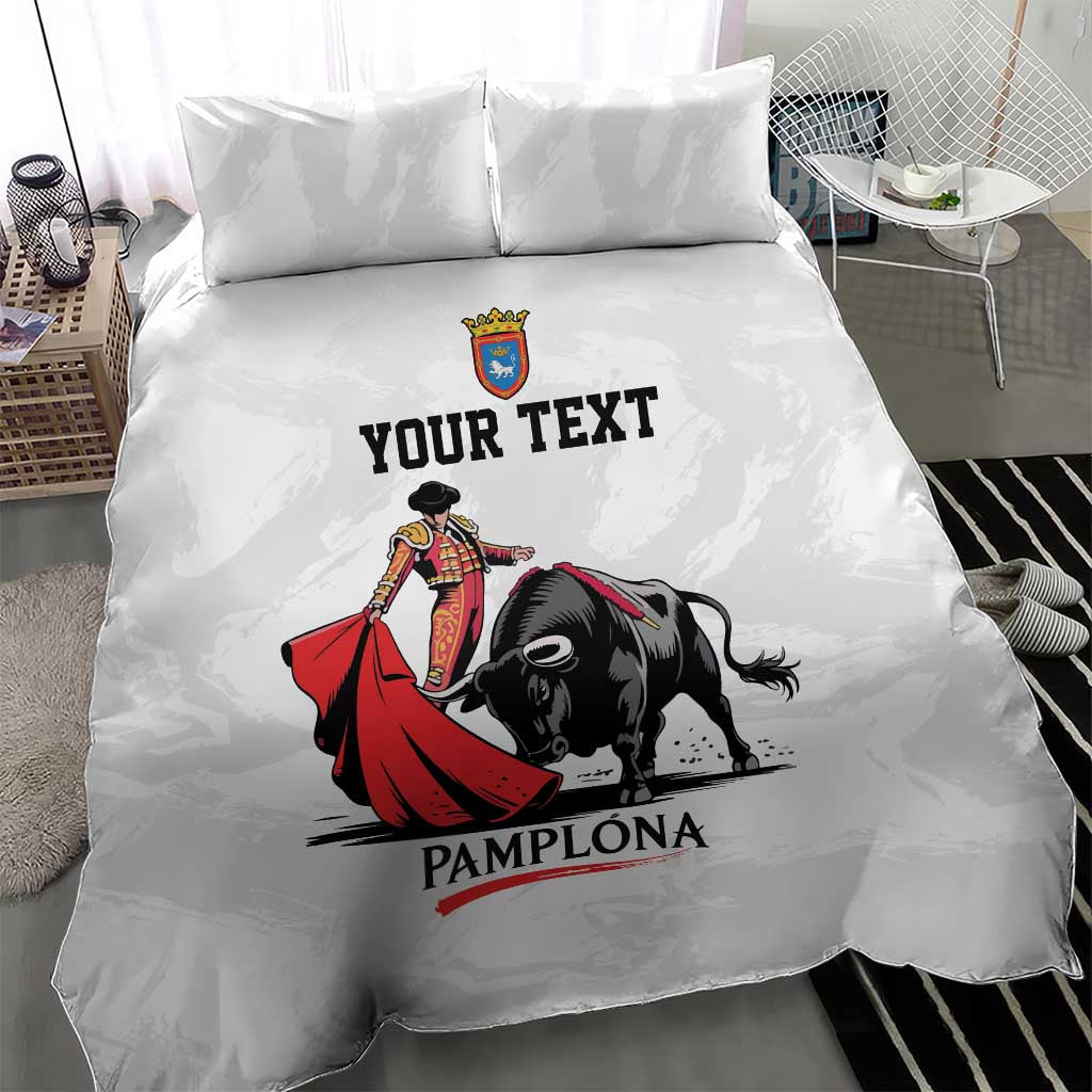 White duvet set with bull and matador print, crown crest, 'YOUR TEXT' and 'PAMPLONA'.