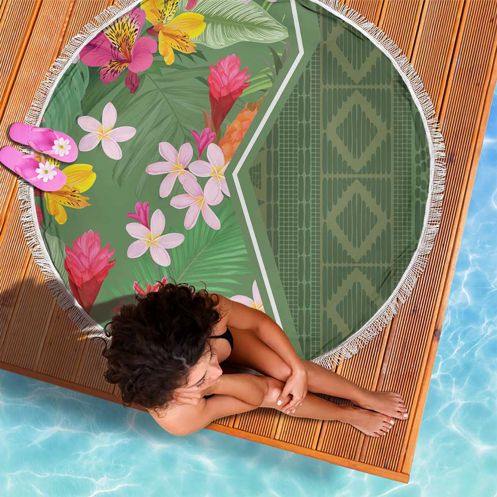 Round green beach blanket with tropical blooms and leaves, white fringed border