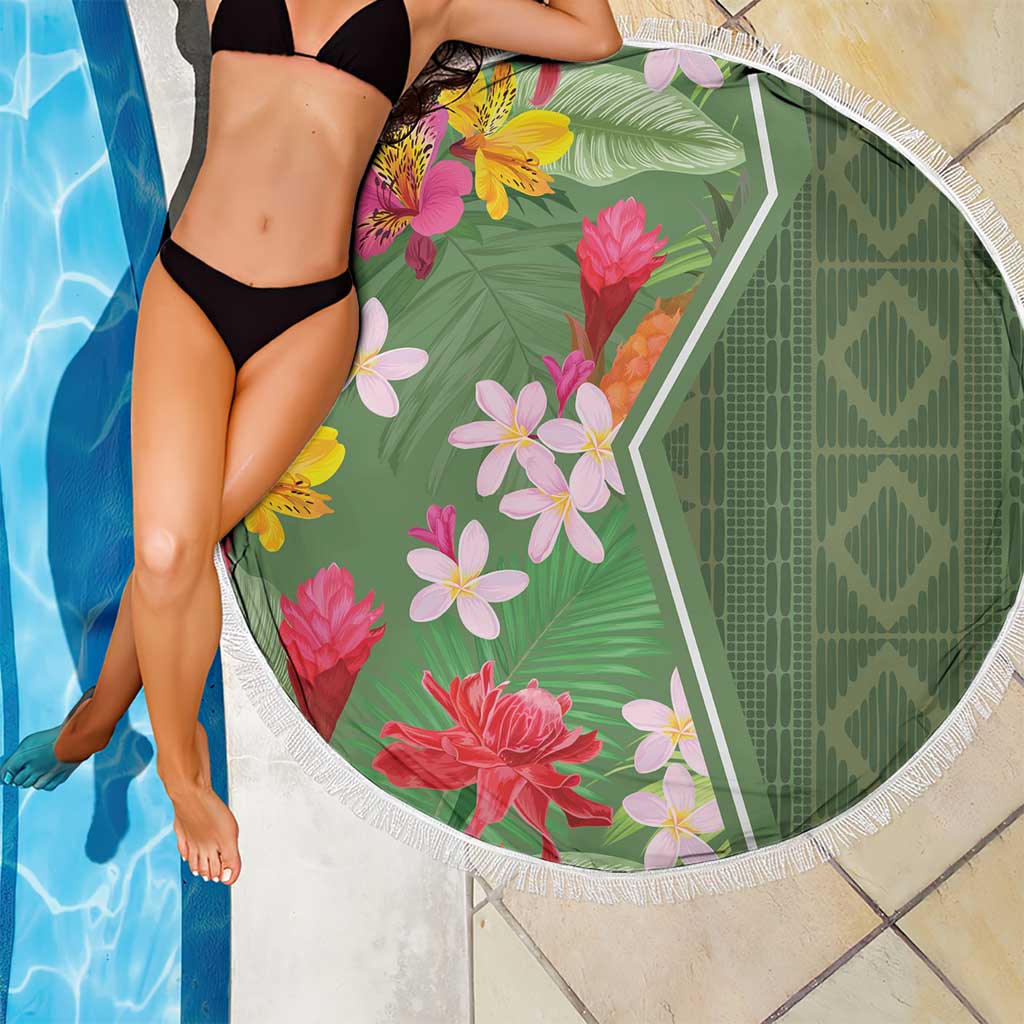Round green tropical floral beach blanket with white fringe edge and leaf background