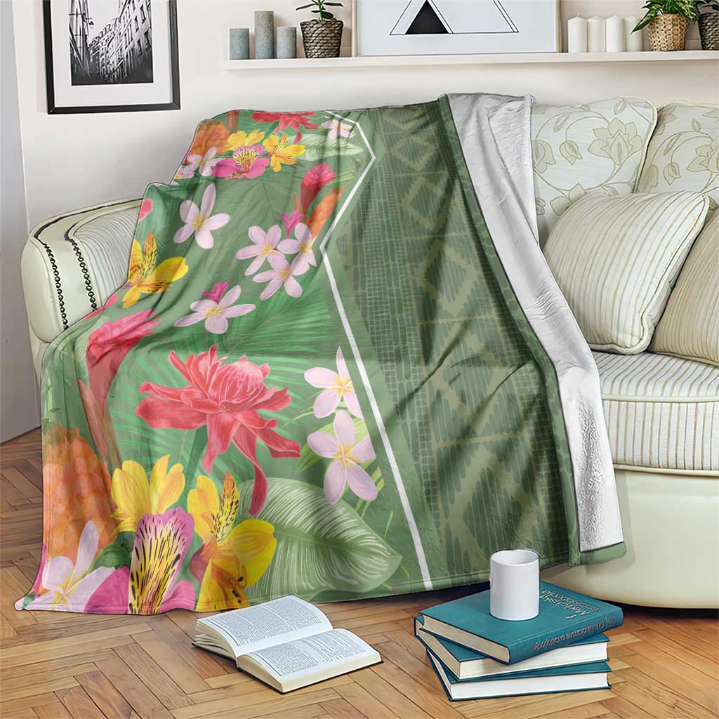Green floral tropical blanket with pink, yellow, and orange flowers and geometric border