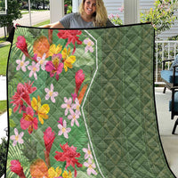 Green tropical floral quilt with quilted diamond stitching and multicolor flower print