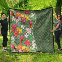 Green tropical floral quilt with multicolor blossoms and quilted diamond pattern on green side