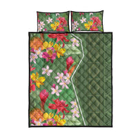 Green quilt bed set with tropical flower print, two pillowcases, top view