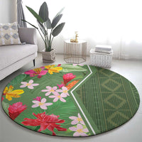 Round green tropical flower rug with leaf pattern and white edging, full view