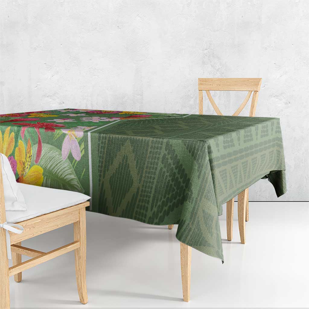 Green tropical floral tablecloth draped over dining table with folded edge detail