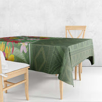Green tropical floral tablecloth draped over dining table with folded edge detail